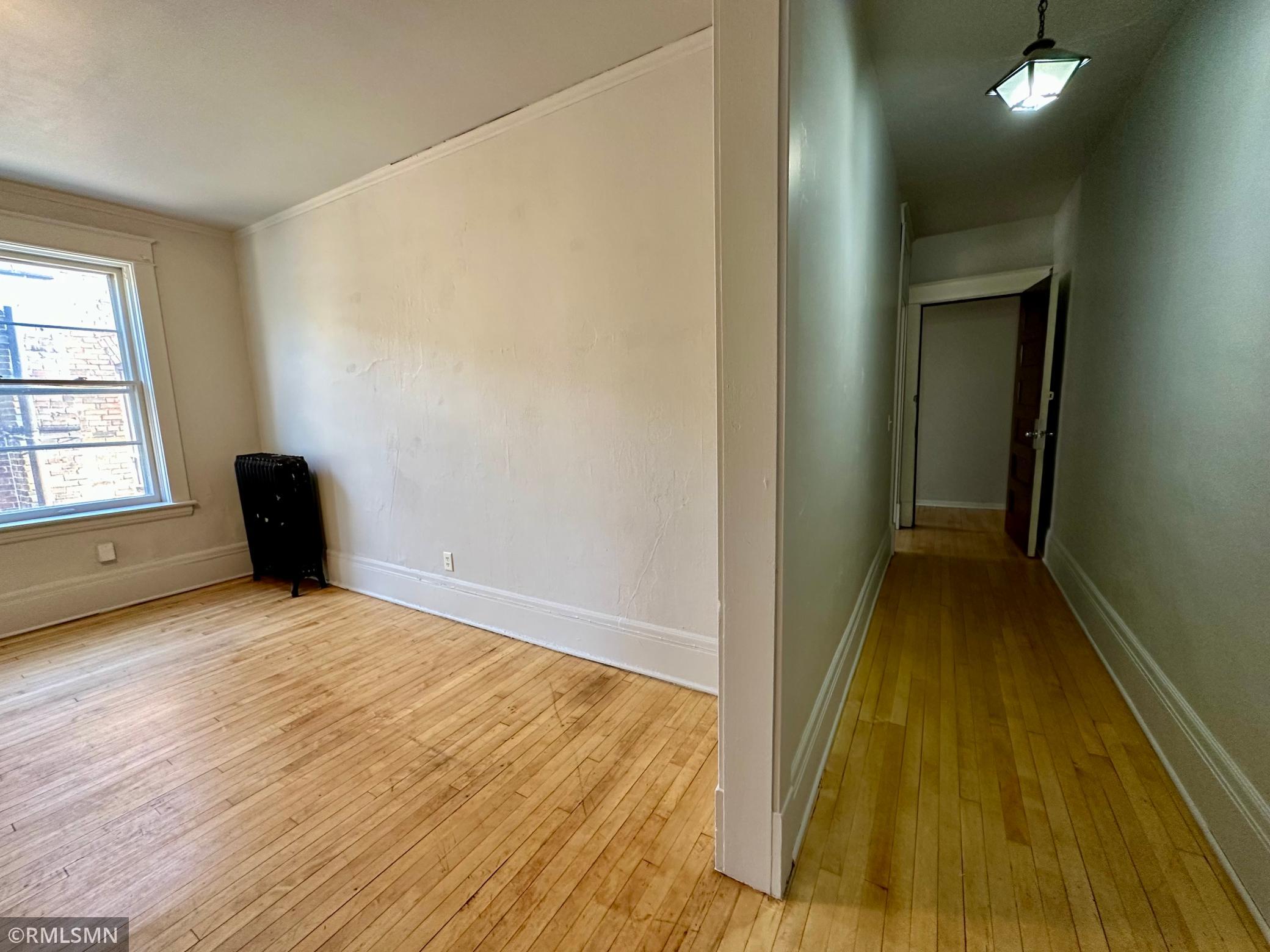 Apt 1 - Living room/hallway - original re-finished hardwood floors