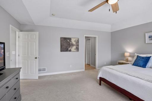 Primary bedroom showcases a tray ceiling and ceiling fan for comfort1879 Sandbar Circle - Spacecrafting - 0029.jpg