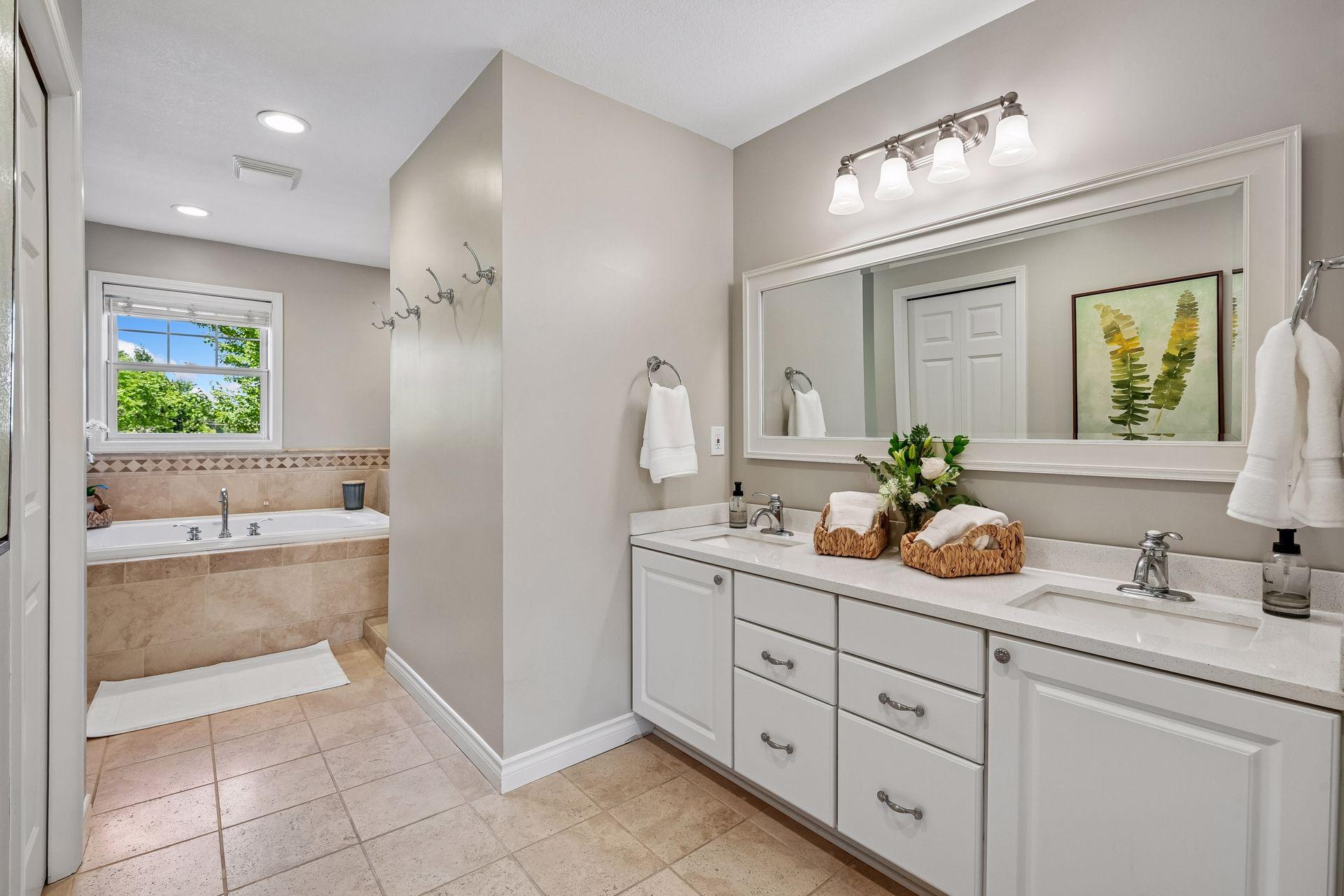 Primary full bath offers double sinks and plenty of storage