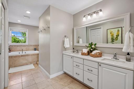 Primary full bath offers double sinks and plenty of storage