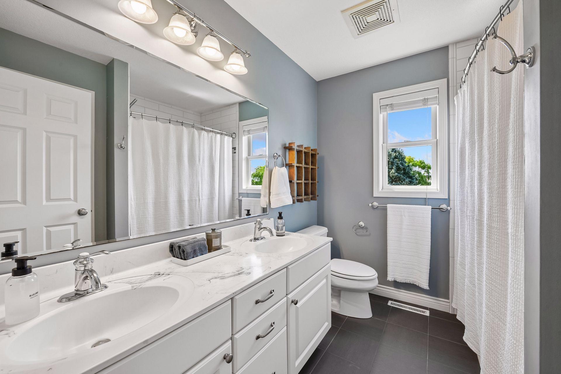 Convenient full bath and double sinks separate the two south side bedrooms