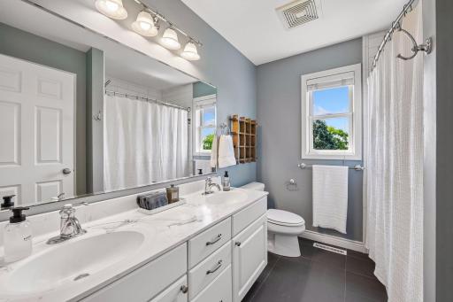 Convenient full bath and double sinks separate the two south side bedrooms