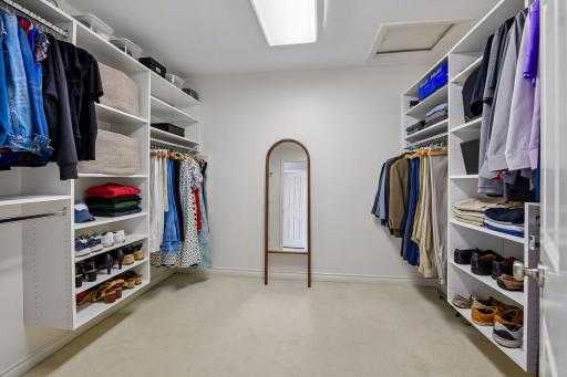 Primary walk-in closet complete with closet organizers