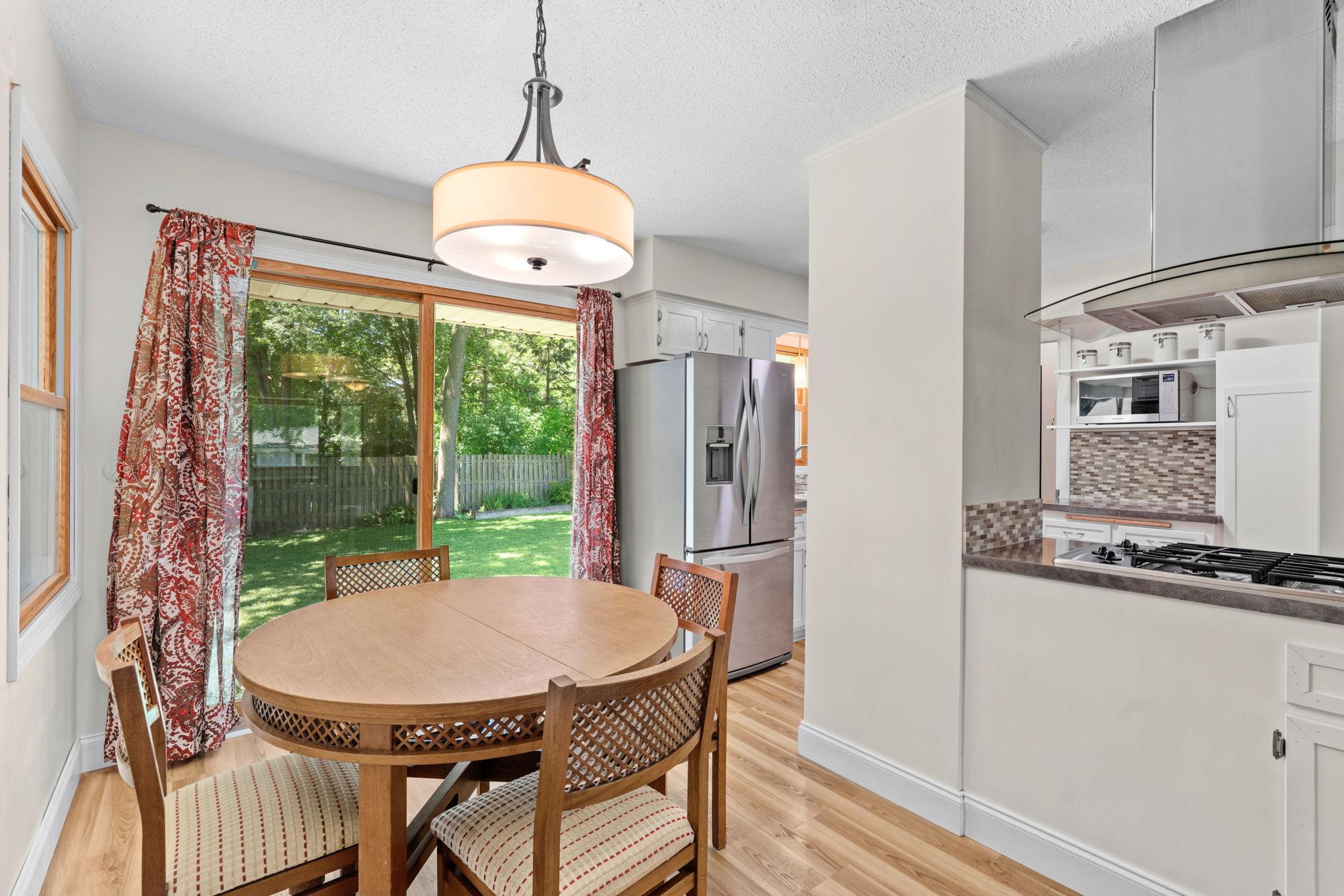 Eat in kitchen with sliding glass doors leading to the fenced in backyard