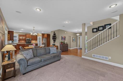This inviting living room provides the perfect place to unwind while remaining connected to the heart of the home, making it easy to stay engaged with family and guests.
