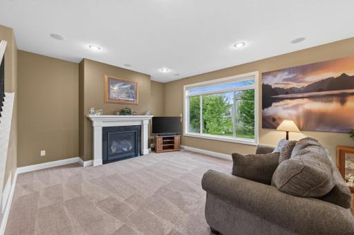 Whether you're enjoying a cozy night by the fireplace or taking in the scenic backyard views, this spacious living room offers the perfect blend of comfort, light, and timeless appeal.