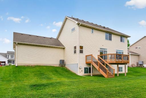 An impressive backyard with abundant green space and direct deck access provides a wonderful setting for entertaining and outdoor activities.