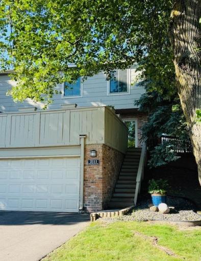 Exterior stairs on the right lead up to the front deck and entrance to the home.