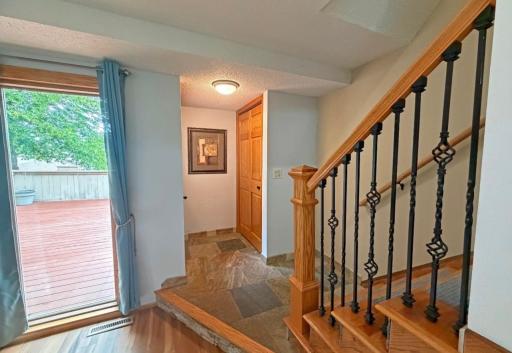 Ceramic tiled foyer, floor to ceiling window at living room and a handy coat closet are seen here.