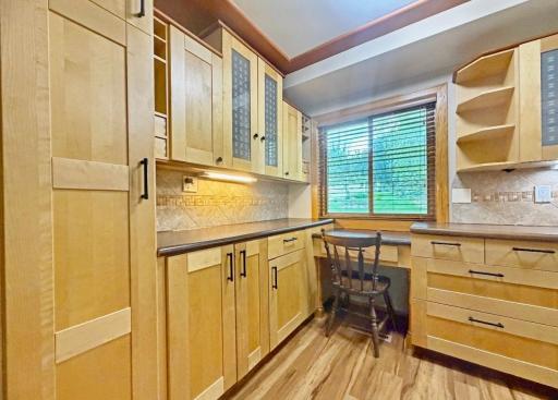The new homeowner will love the renovated kitchen with a built-in desk, drawers, cabinetry, cubbies & shelves.