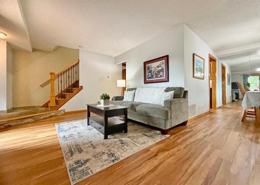 This expansive living room is flooded with natural light. It also features gorgeous flooring and carpeting throughout the home.