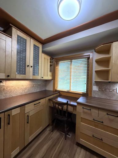 The built-in desk and drawer offer practicality for busy homeowners.