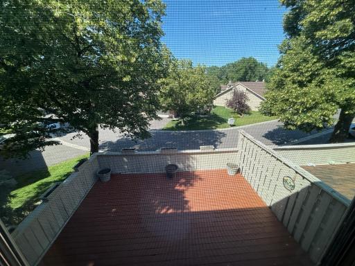 The second bedroom has a pleasant view of deck and trees.