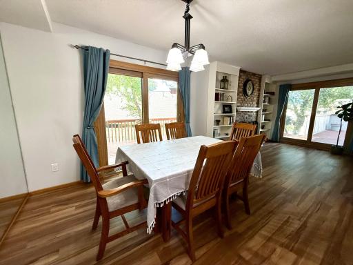 A lovely chandelier offers light and style for meals with loved ones. Luxe drapery, blinds and other window treatments in the home stays with the new homeowner.
