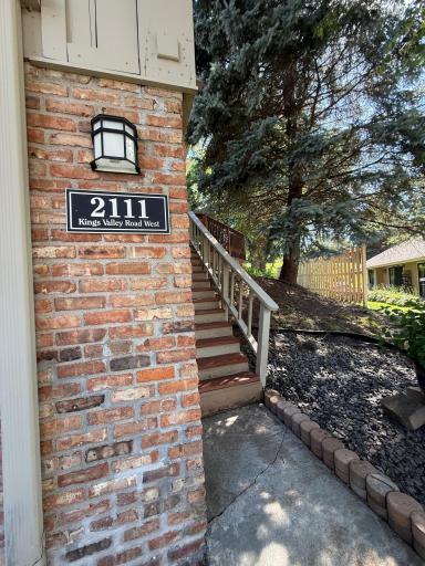 Gorgeous brick accents at the exterior are found. 2 options to access the home from the front: through the garage or the steps to the front door.