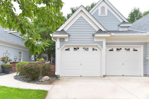 Attached 2-car garage provides convenient parking with direct access to the home. Private front courtyard with mature landscaping and a welcoming walkway to the entrance.