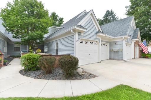 Attached 2-car garage provides convenient parking with direct access to the home. Private front courtyard with mature landscaping and a welcoming walkway to the entrance.