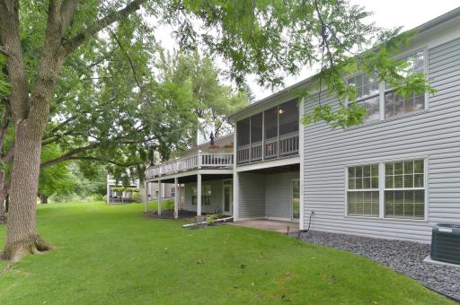 Rear exterior featuring a screened porch, deck, and walkout lower level.