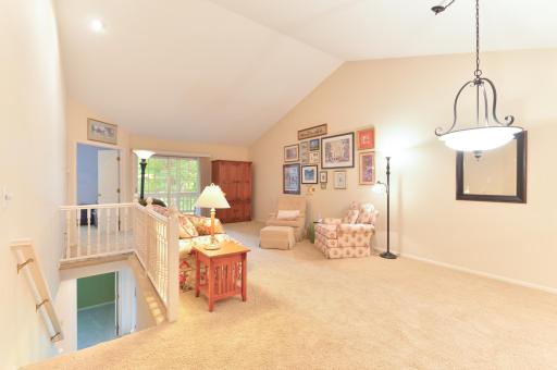 Vaulted ceilings enhance the spacious feel of the main-level living room, with access to the screened deck just beyond.