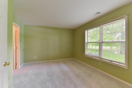 Lower-level flex room with a large window offering plenty of natural light.