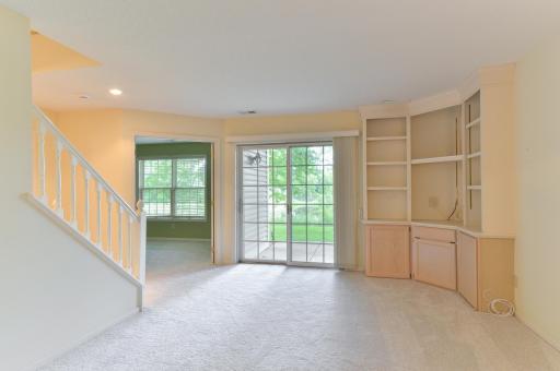 Lower-level family room features built-in cabinetry and a walkout to the patio and backyard.