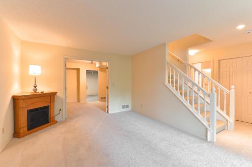 Another view of the spacious lower-level family room with built-ins and adjoining bonus room.