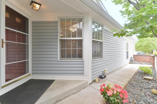 Rear exterior featuring a screened porch, deck, and walkout lower level.