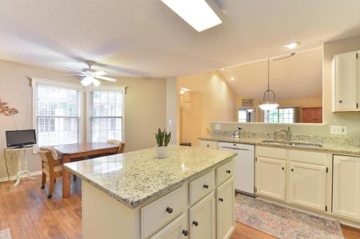 Open kitchen with generous counter space and a center island flows seamlessly into the main living area.