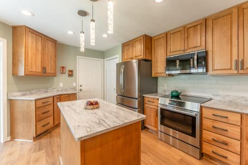 Kitchen has been completely updated with maple cabinetry, quartz countertops and stainless steel appliances.