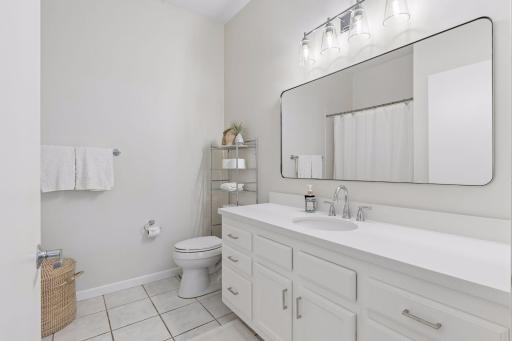 This full bathroom has a new vanity top/sink combo, mirror, lighting and faucet. Not shown is the deep tub with shower head.