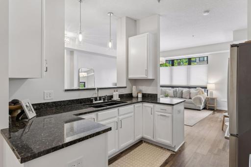 Feel the height of the space. The opening above the sink is a breakfast bar with new lighting overhead.