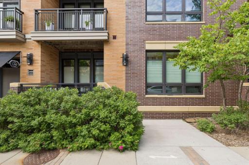 Just a nice view of the condo with the 6 large windows and their consistent window treatments. Hop right onto the sidewalk.
