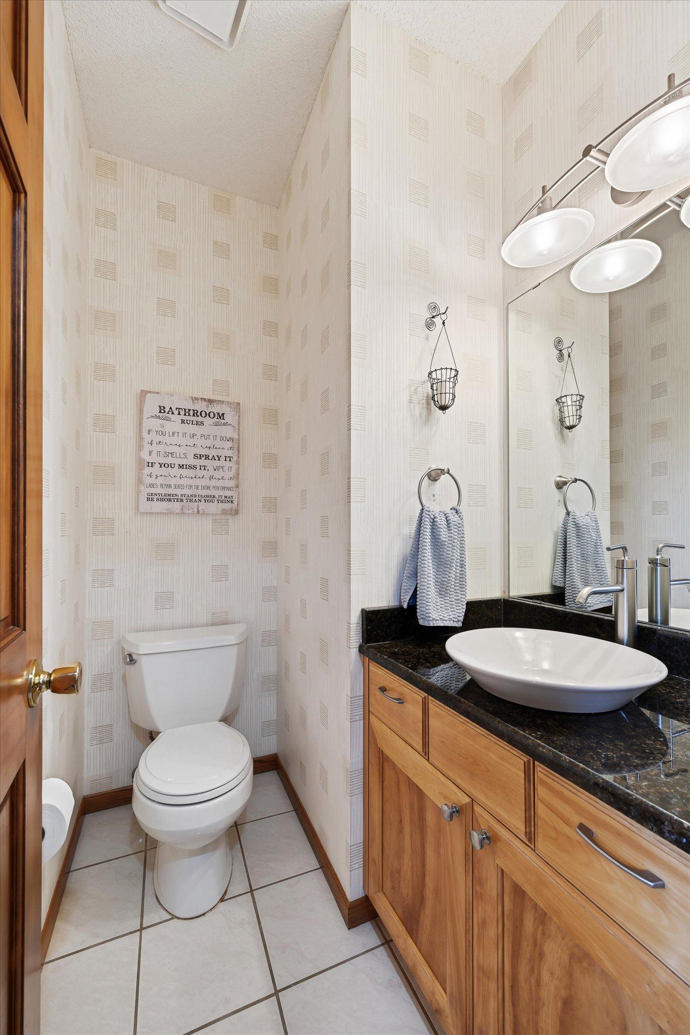 The main-level half bath adds convenience for everyday living and entertaining.