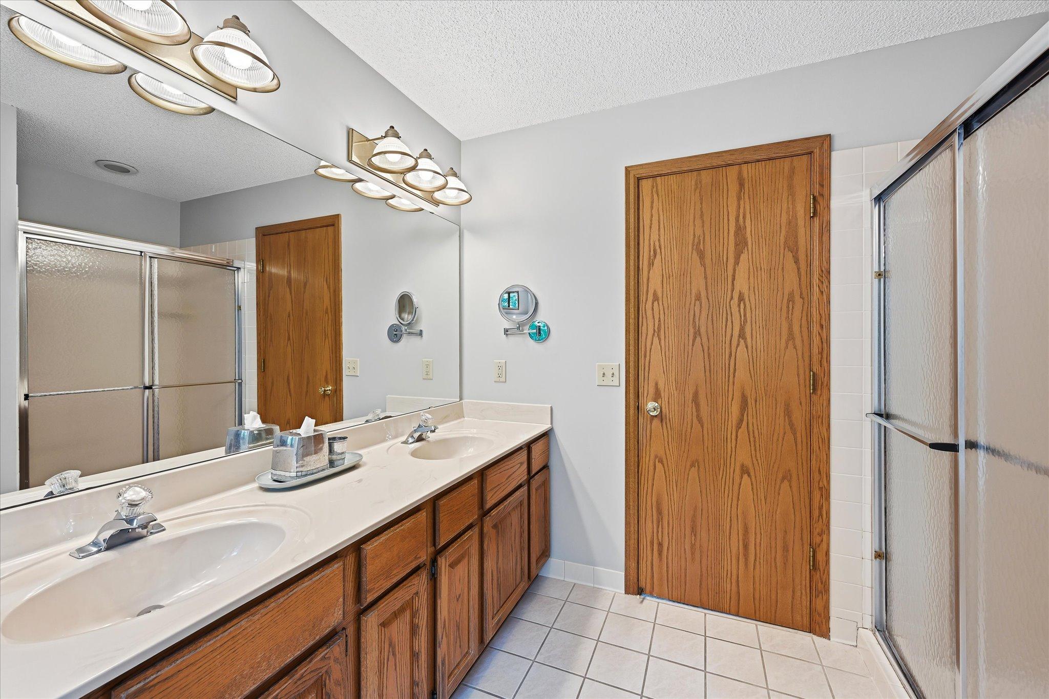The private primary bath features a separate tub and shower, creating a functional and comfortable retreat.