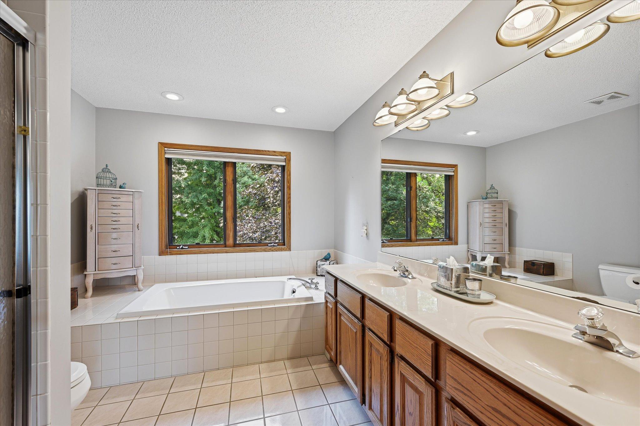 The private primary bath features a separate tub and shower, creating a functional and comfortable retreat.