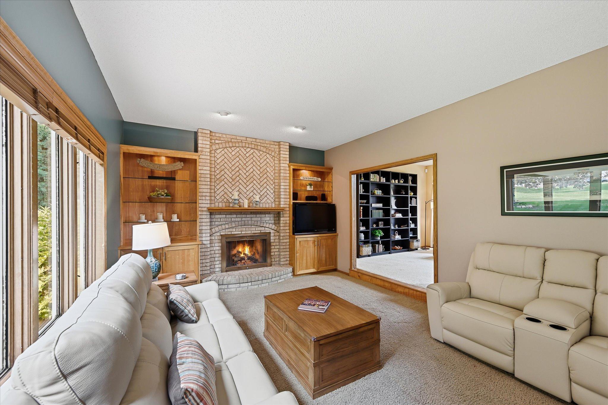 A fireplace and built-in cabinetry create a natural focal point in the spacious family room.