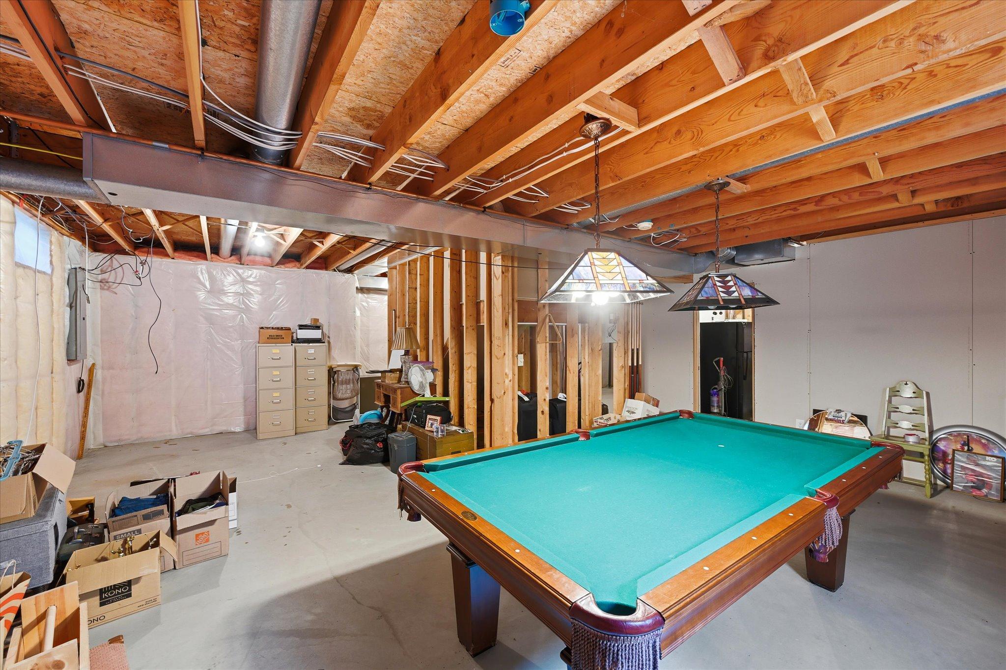 The unfinished lower level offers valuable potential for future finished living space, recreation, a home office, or additional storage.