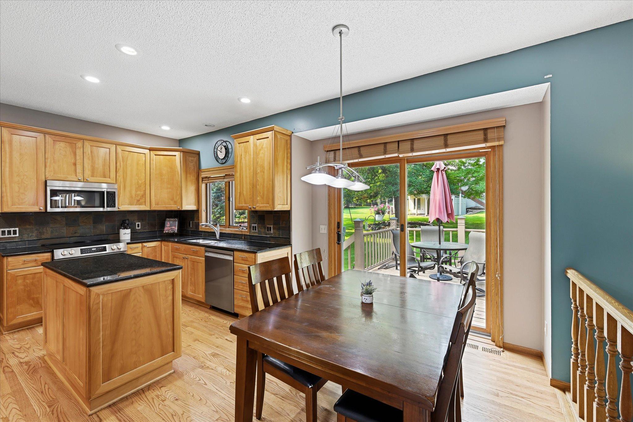 The kitchen flows naturally into the informal dining area, with direct access to the deck and backyard.