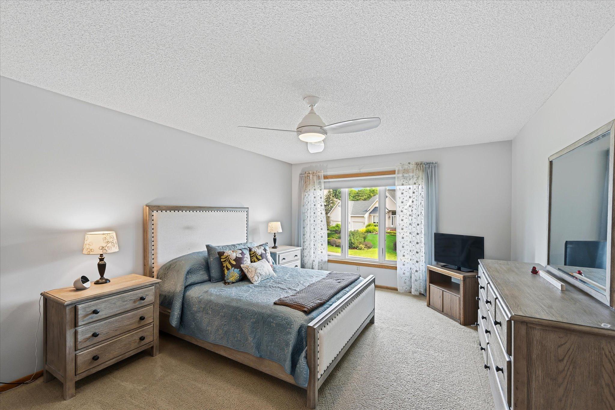 The generously sized primary bedroom offers plenty of room for a comfortable bedroom setup along with convenient access to the private bath and walk-in closet.