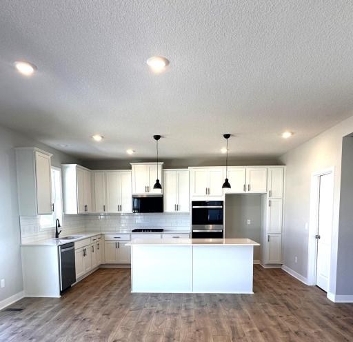 Photo of previous completed home with signature style kitchen. (Previous color package, colors will vary).