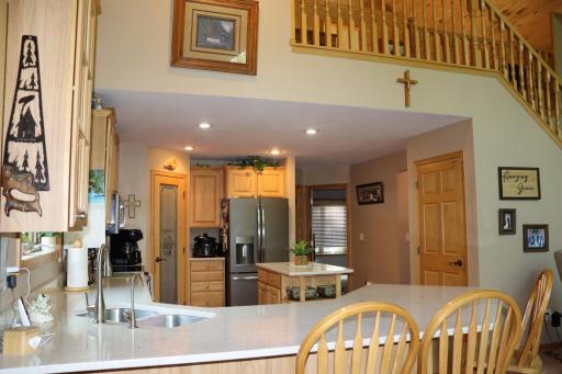 Large kitchen with walk-in pantry, hickory cabinets and quartz countertops