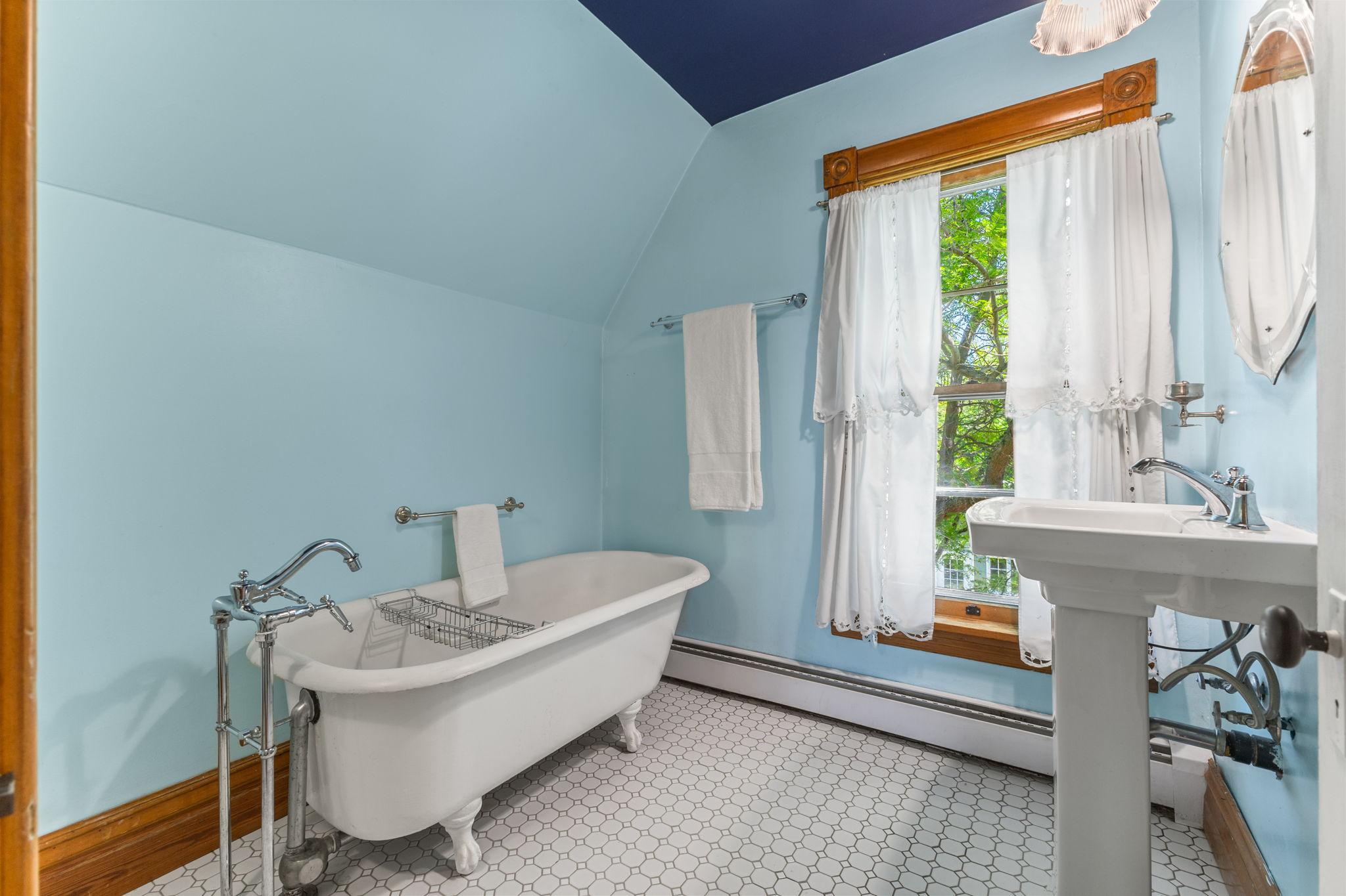 Upper level bathroom with claw foot tub and pedestal sink!