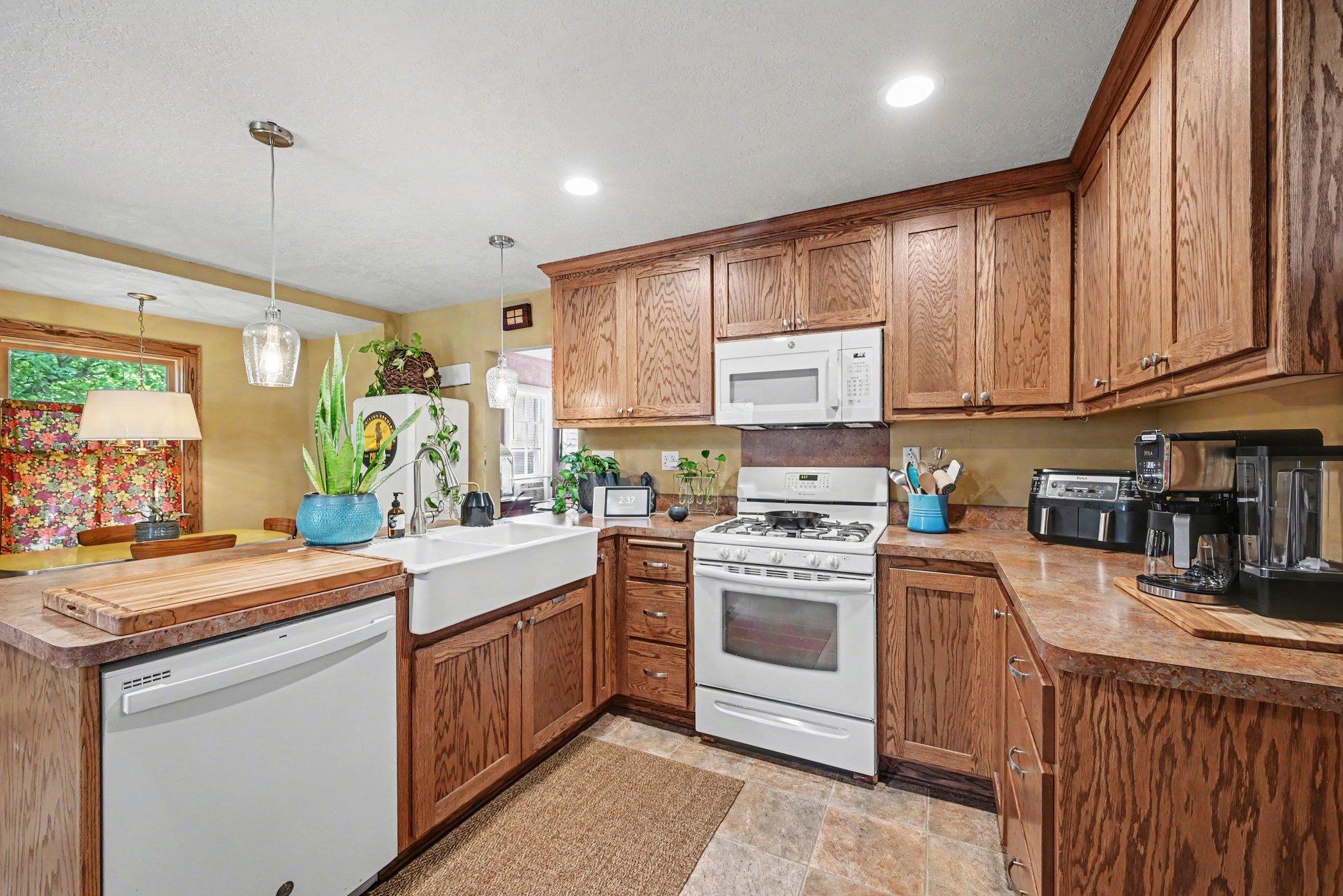 Kitchen flooring, appliances include gas range, microwave, dishwasher and full-size refrigerator. Recessed lights offer plenty of light for your kitchen meal prep.
