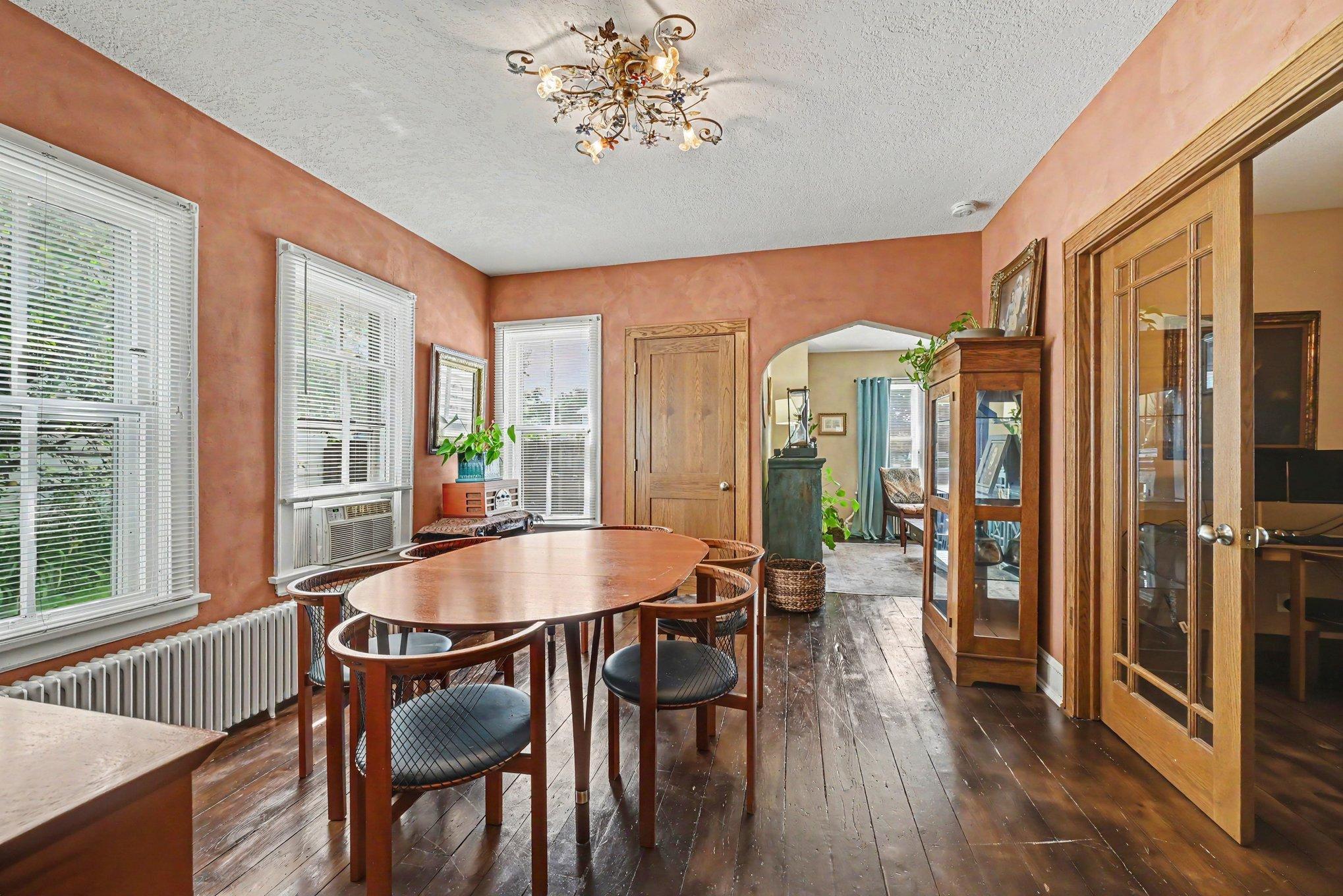 Lovely formal dining room is expansive for both dining table and buffet. Additional features are the stunning woodwork, paneled doors, French doors and hardwood floors.