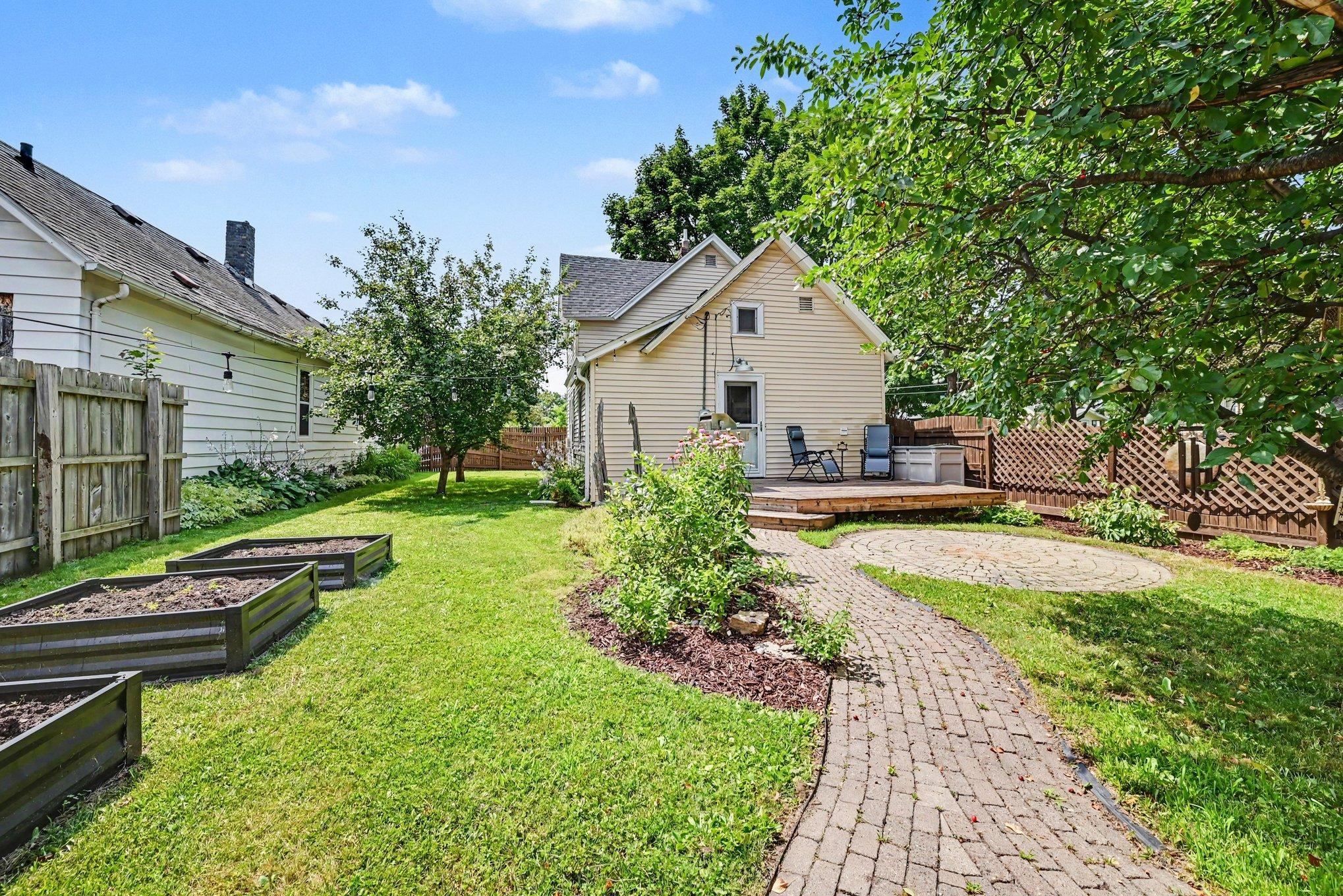 The backyard is lovely with cobblestone path, circular patio, garden beds, Honeycrisp apple tree, cherry tree and more gardens. The deck is perfect for outdoor entertaining. The gas grill stays for your backyard BBQ!