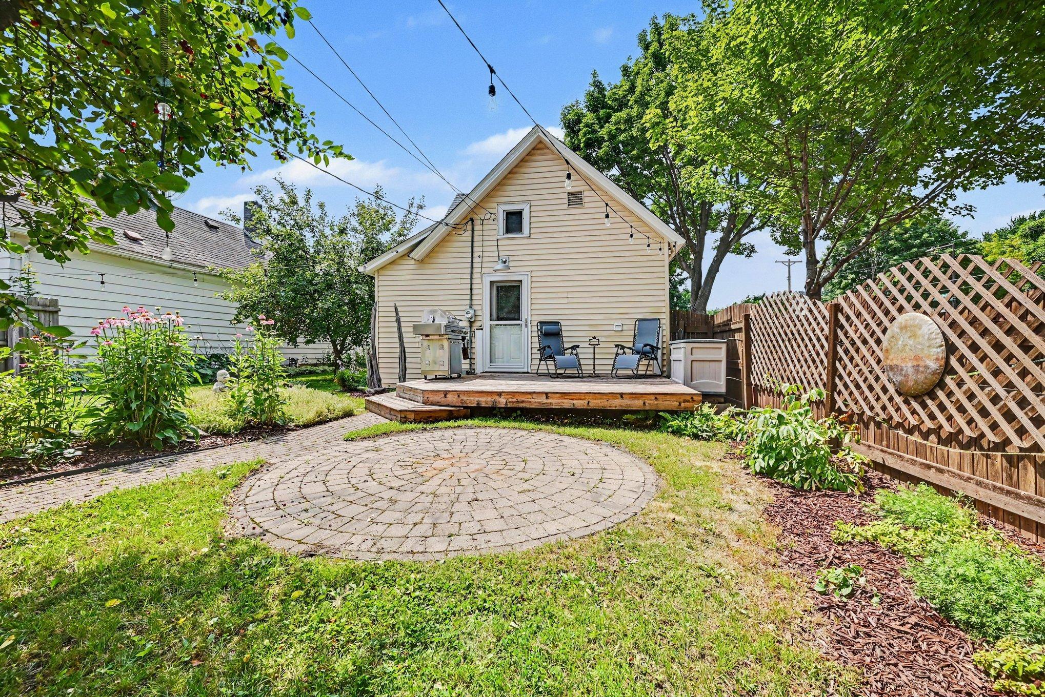 The artisan privacy fence has a wonderful design, not to be missed! And encloses the backyard on three sides.