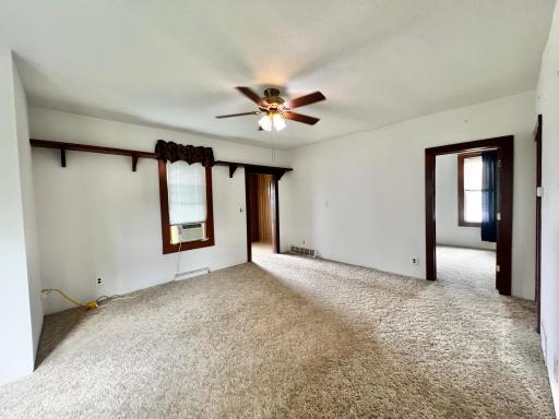 Living Room with view of front entry and main floor bedroom.