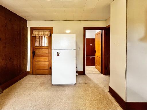 Kitchen with view of Back Entry, and view of main floor 3/4 Bathroom.