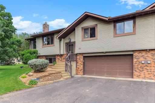 Beautiful split-entry home with excellent curb appeal featuring maintenance-free siding, brick accents, and a spacious two-car attached garage.