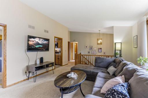 Living room with open sightlines to the foyer. The flexible layout offers plenty of space for everyday living and easy access to the kitchen and hallway.